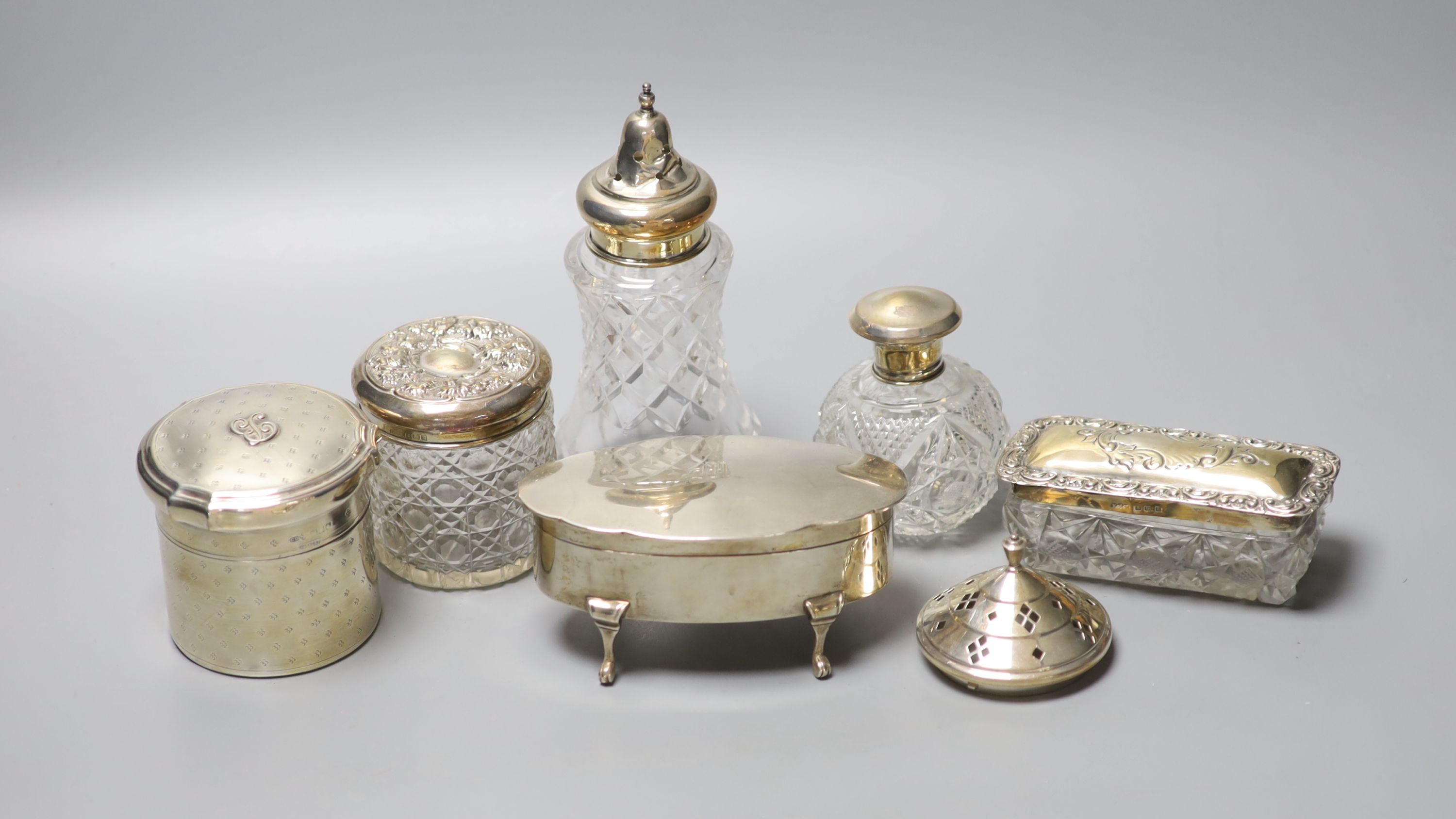 A George V silver oval trinket box, 12.5cm, a silver toilet canister and other toilet jars etc.